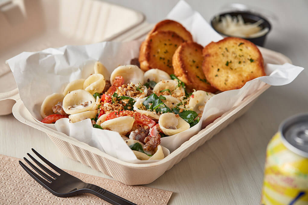 Orecchiette pasta carries sautéed spinach, red bell peppers, and fennel sausage tossed with a lemon cream sauce, topped with toasted breadcrumbs.