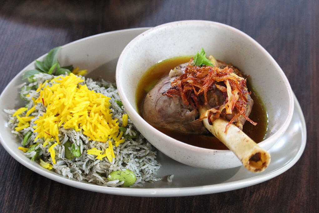 Slow Cooked Lamb Shank with Persian spices, caramelized onions, saffron, fava beans and dill basmati rice