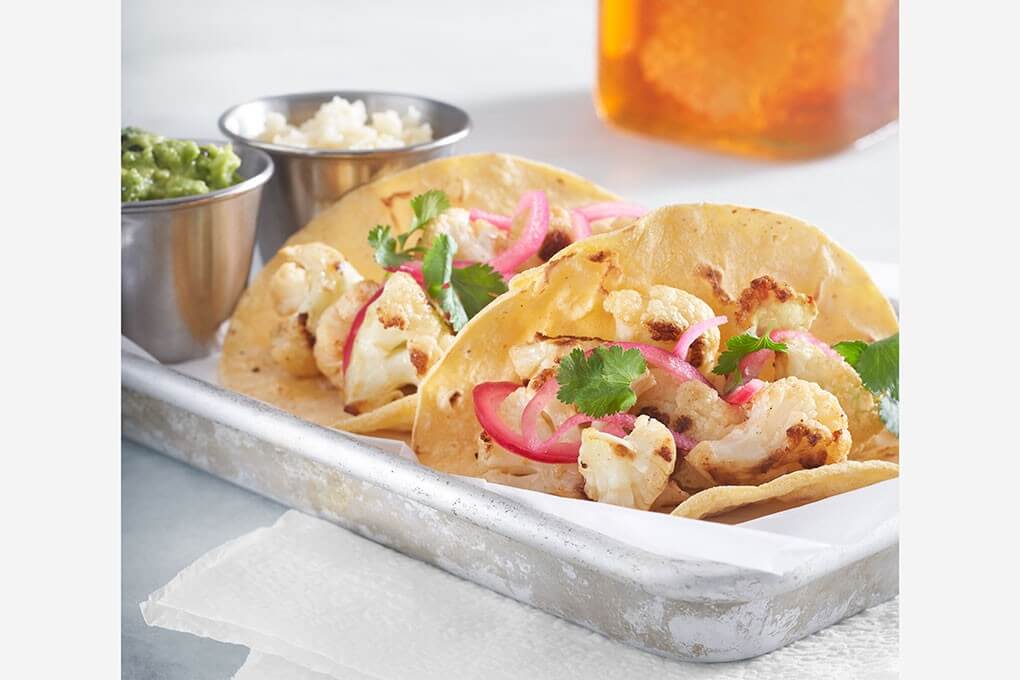 Chef Dave Woolley’s creative plant-based tacos feature roasted cauliflower, avocado mash, honey-pickled onions, honey combtija (broken honeycomb mixed with cotija cheese) and cilantro.