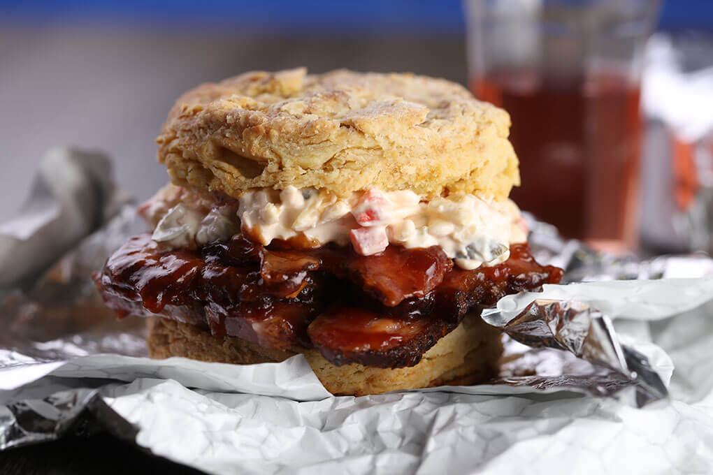 Black garlic barbecue sauce and jalapeño pimento cheese bring big flavor to this Smoked Brisket Biscuit.