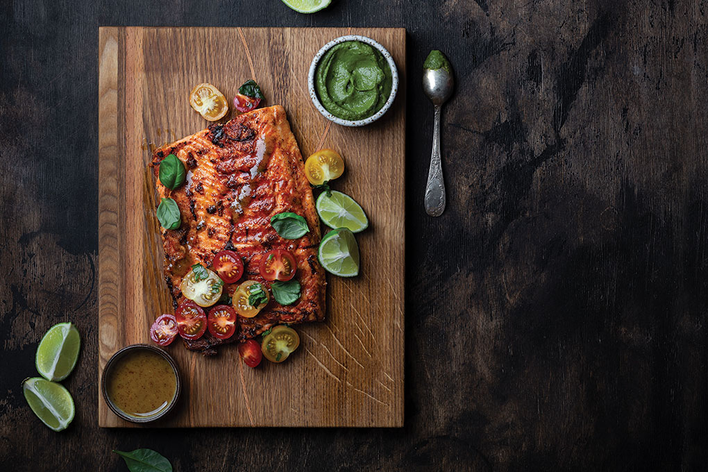 A passionfruit-ancho chile glaze gives this a signature flavor story. Over top, a tumble of heirloom cherry tomatoes tossed in a yuzu vinaigrette adds a nice seasonal touch. A creamy whipped avocado sauce is served on the side.