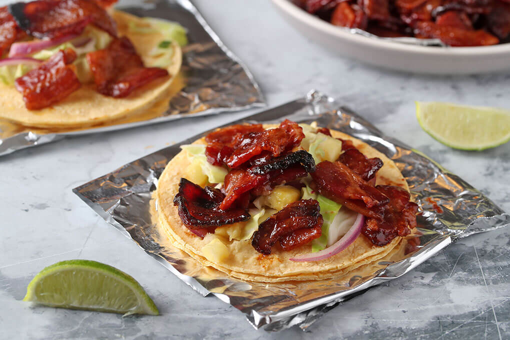 Perfect for breakfast, brunch or any time, Bacon Burnt Ends Tacos feature Smithfield Ready to Eat Sliced Bacon coated in a glaze made with honey, barbecue sauce and chicken stock. After baking until sweet and sticky, the bacon goes into a corn tortilla, along with a crisp and acidic pineapple-cabbage slaw.