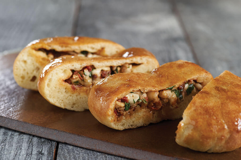 Kiran Verma, chef/owner of Kiran’s in Houston, fills and bakes naan dough for her Indian-Mediterranean Caprese Stuffed Naan.