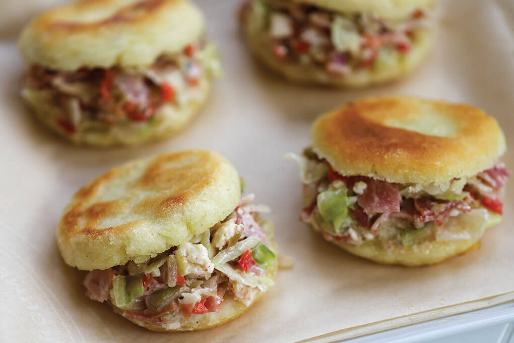 Aussie Lamb Cold-Cut Arepas replace the traditional sub roll with a Venezuelan-style arepa.