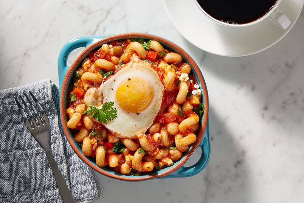 Cannellini, garbanzo beans, and cellentani pasta in a rich ragu of fresh tomatoes, spicy sambal, balsamic vinegar, and goat cheese, finished with a basted egg cooked right on top.