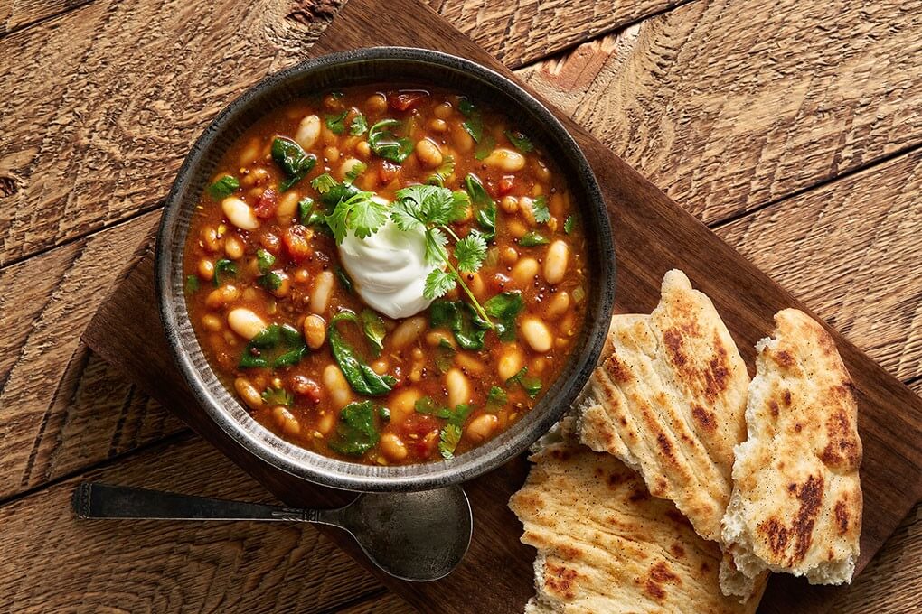 Chef Jeffrey Quasha toasts coriander, mustard seeds, and cumin seeds in oil then layers with fresh ginger, garlic and Bush’s Baked Beans in this creative mashup.