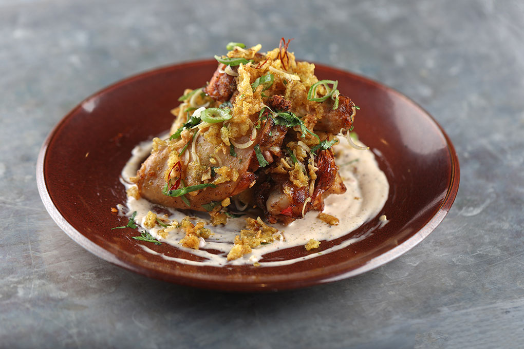 These Pork “Wings” bring big flavor with a tempura-style batter and an aromatic/spicy Thai chile crust. A Southeast Asian twist on white barbecue sauce brings in coconut milk, fish sauce, Szechuan peppers and cilantro. 