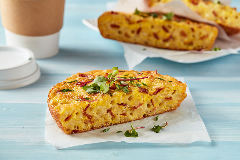 This Naples-inspired handheld pulls from the classic quiche Lorraine to evoke flavors of a French bistro using ditalini, smoked bacon, Gruyere, and chives.