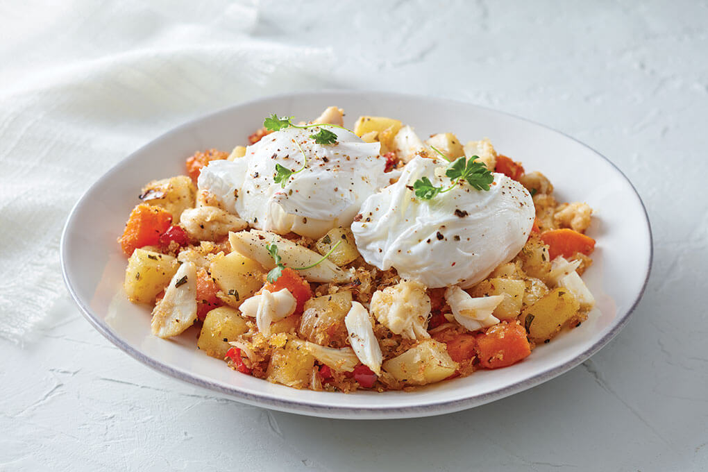 A trio of Idaho russets, yellow and sweet potatoes forms a comforting base for this Idaho Potato and Crab Hash with Poached Eggs.