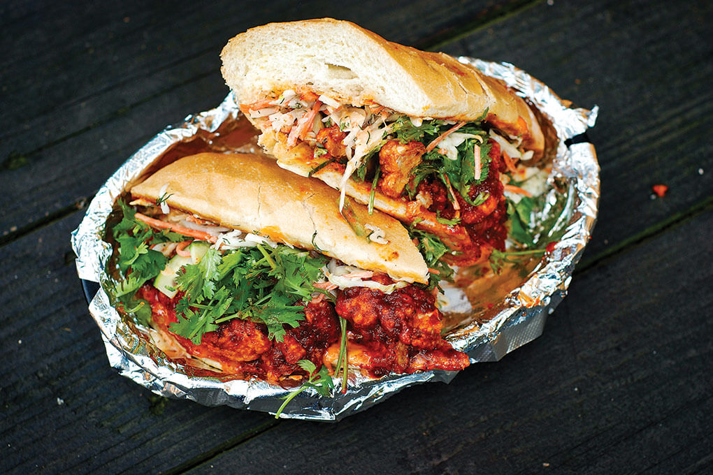 Mopho’s chicken vindaloo sandwich gets a boost of flavor from a coconut-ranch dressing.