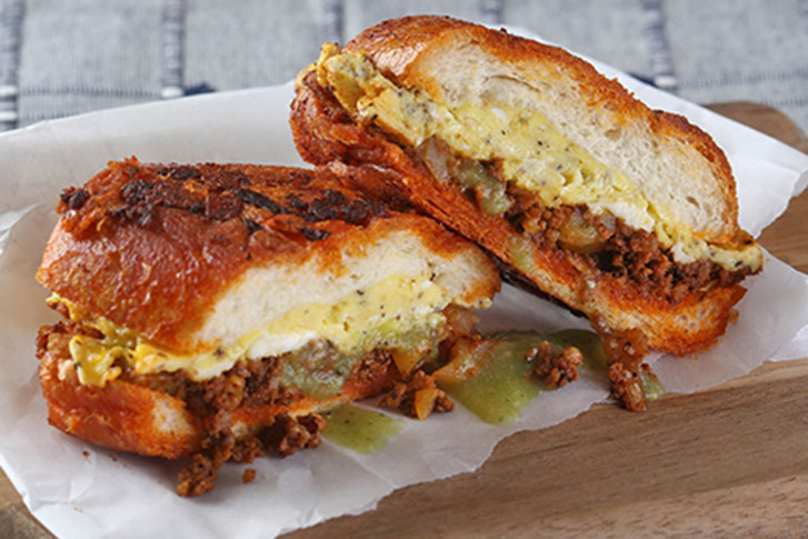 This comfort-centric, hearty Mexican sandwich stars pambazo bread that’s dipped and fried in smoky guajillo sauce. Here, the rolls are split and filled with chorizo, potato, onion, scrambled egg and queso fresco.