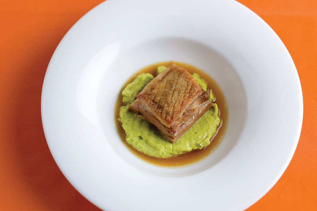 Jennifer Jasinski demonstrates cardamom’s savory side in her Cardamom-Scented Pork Belly with Curried Garbanzo Bean Purée at Denver’s Rioja restaurant.