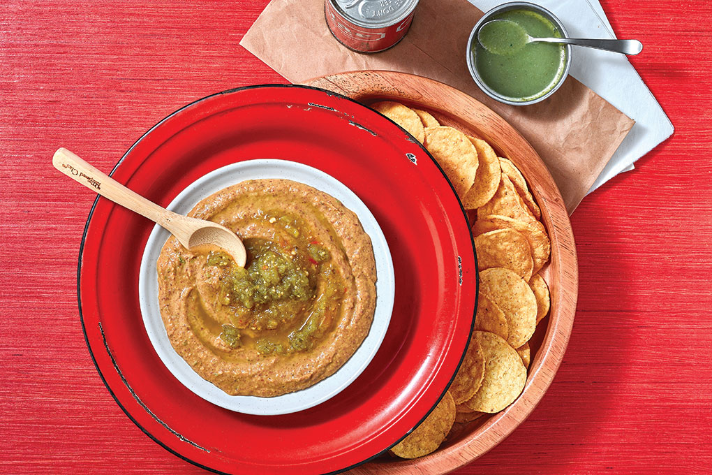 This Salsa Verde Hummus combines the plant-centric power of hummus with the always popular flavors of Mexican fare. Garbanzo beans and black beans, seasoned with Mexican spices, are blended with tahini, garlic, lemon juice and olive oil. A swirl of salsa verde completes the dip.