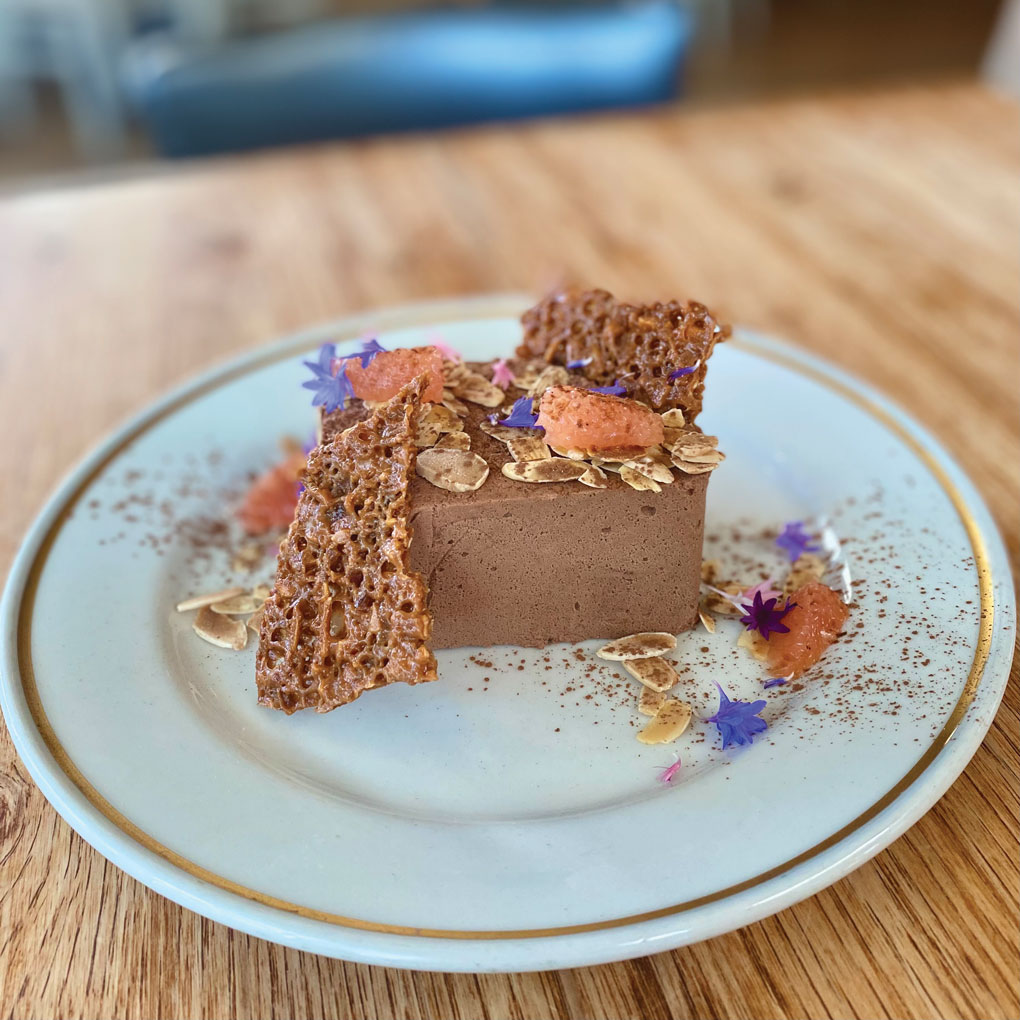 The Mousse at Grampa’s Pizzeria in Madison, Wis., balances cardamom with strong chocolate, coffee and burnt orange flavors and is served with grapefruit and sliced almonds.