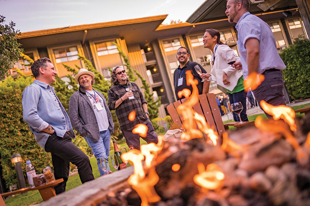 The Nordstrom culinary team enjoys a moment around the firepit during the opening reception.