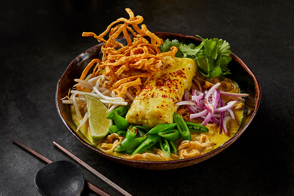 Seafood-centric bowl builds offer an opportunity for creative takes on classic recipes. Jeremy Bringardner’s spin on Southeast Asian Khao Soi is all about building flavor and texture, with Alaska pollock as the central feature. A curry paste forms the base flavor and both fried and boiled egg noodles add contrasting textures.