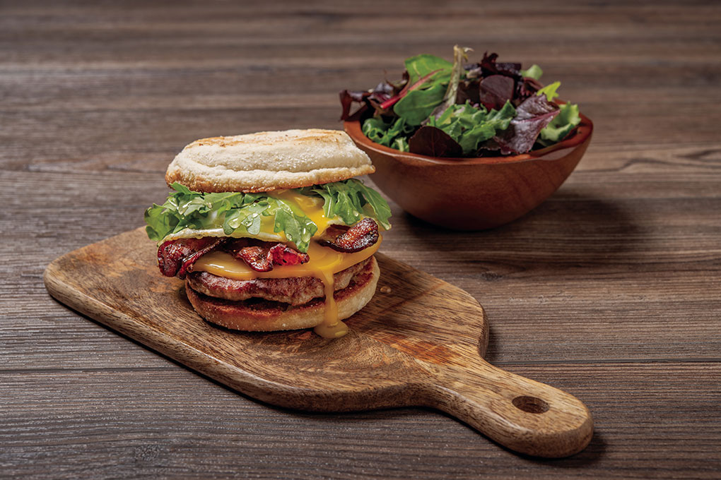 First Watch’s latest LTO is a Million Dollar Breakfast Sandwich, sporting the restaurant’s signature bacon, along with an all-natural pork sausage patty, over-easy cage-free egg, smoked Gouda, fresh arugula and a Mike’s Hot Honey drizzle on a griddled English muffin.