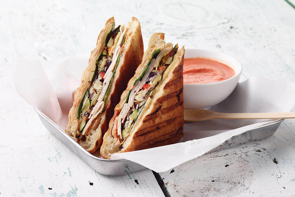 Flavors of Italian antipasto easily convert to a handheld with Butterball Sliced Smoked Turkey Breast as the hero of this Turkey Antipasto Panini.