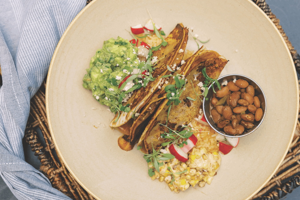 Executive Chef Jordan Harvey at Hearth and Hill menus Short Rib Birria Tacos. Wrapped in crispy flour tortillas and topped with radishes and Oaxacan cheese, he serves them with guacamole, esquites and rice and beans.