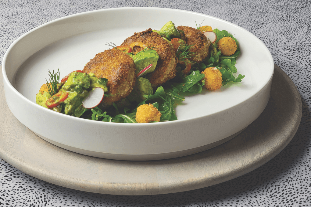 Ian Ramirez sees big opportunity for plant-based seafood, especially among younger consumers. His pan-fried “crab cakes” are layered with an avocado, cucumber and sweet pepper salad tossed in a dill-caper chimichurri and served with crispy Boursin bites.