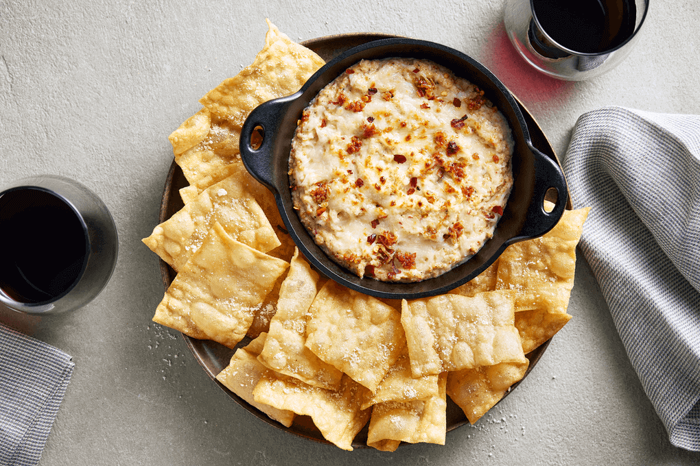 Crispy chips made out of lightly fried Barilla lasagna sheets are dusted with Parmigiano Reggiano and served with a warm three-cheese fondue with spicy ’nduja (Italian spreadable sausage).