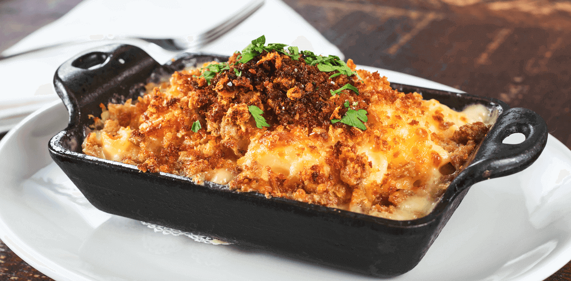 Mac and cheese moves from classic to modern with a clever use of heat elements. Here, fire-roasted jalapeños stud the cheese sauce, and the dish is topped with a Mexican chorizo-spiced chicharrón crumble. Mac and cheese moves from classic to modern with a clever use of heat elements. Here, fire-roasted jalapeños stud the cheese sauce, and the dish is topped with a Mexican chorizo-spiced chicharrón crumble.