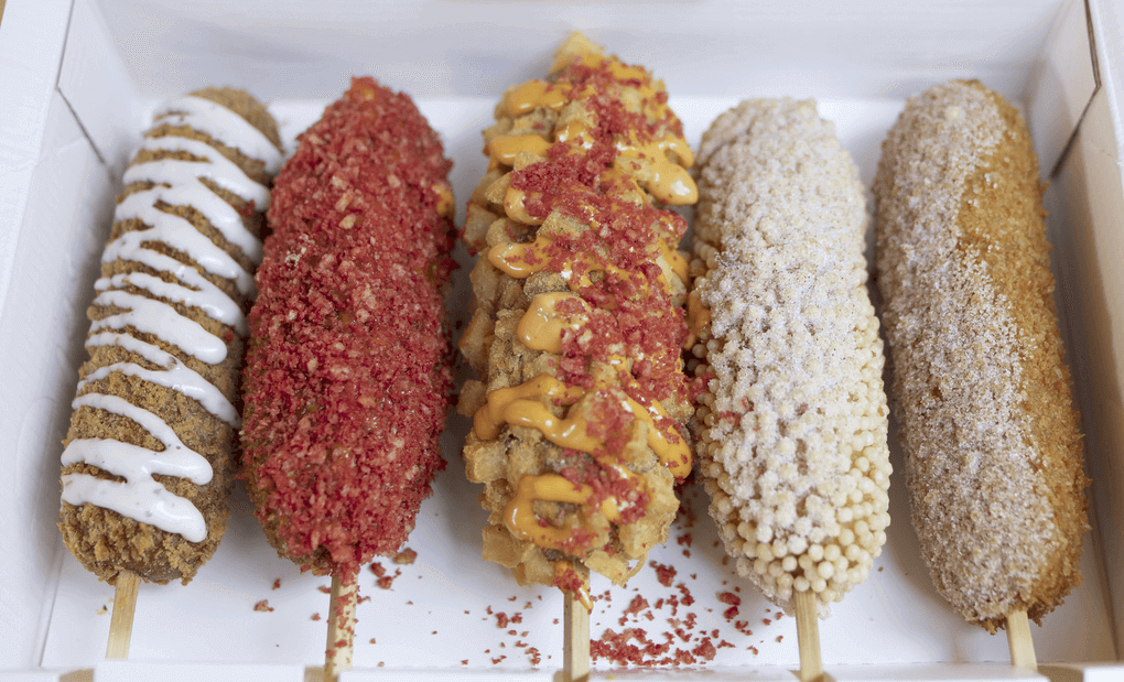 Korean-style street corn dogs are on offer at Two Hands Corn Dogs, with a variety of unique, crispy coatings including rice pearls, fried potato cubes and crushed Flamin’ Hot Cheetos