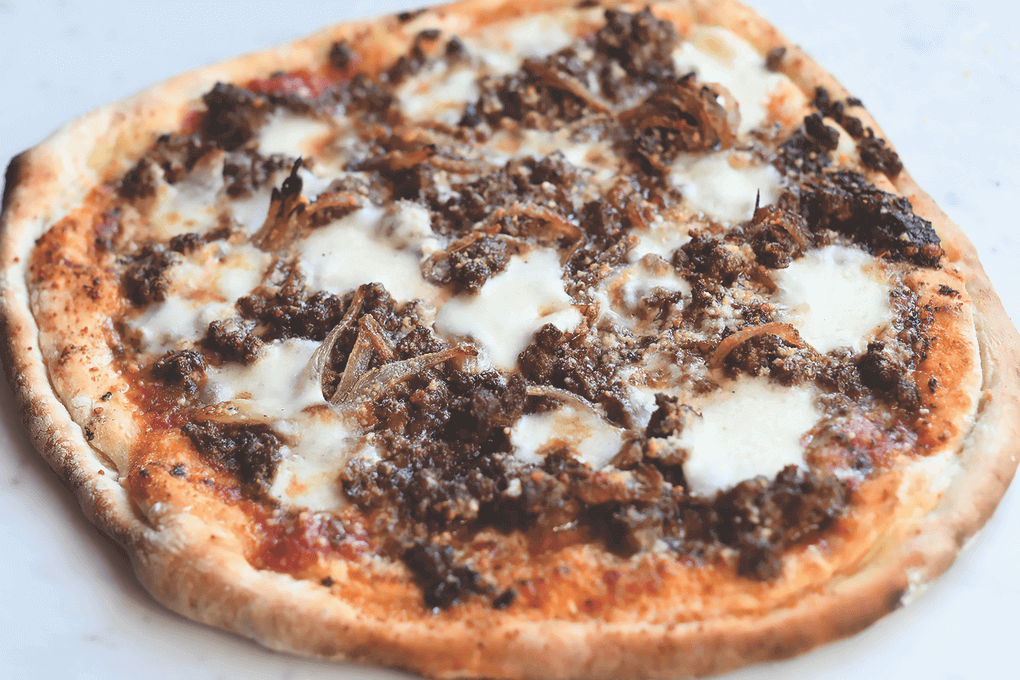 Cindy Pawlcyn uses pizzas at Mustards Grill to help carry seasonal specials. Her Lamb Merguez Pizza packs big flavor, with ground lamb (seasoned with chile powder and sweet paprika), sheep’s milk pecorino and mozzarella, tapenade and a light tomato sauce.