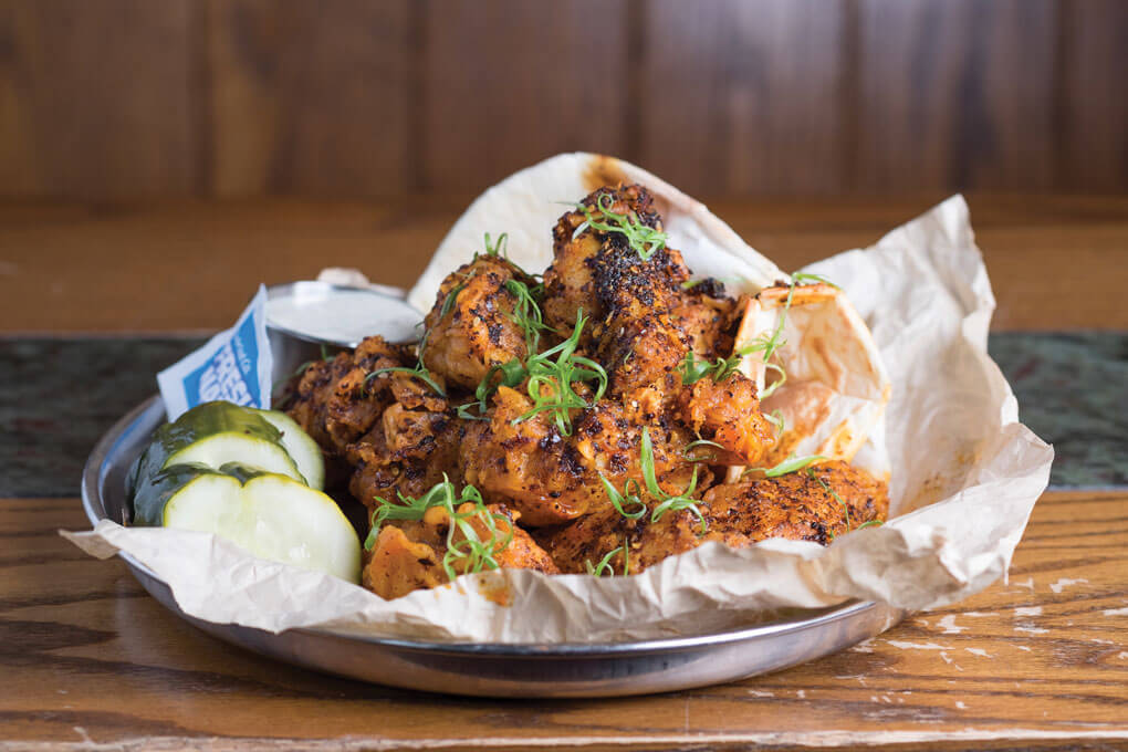 In a clever play on Nashville hot wings, Pub Royale serves India Hot Chicken Wings, showcasing flavors like Kashmiri masala spice and chile chutney. They’re served with housemade naan and spicy pickles.