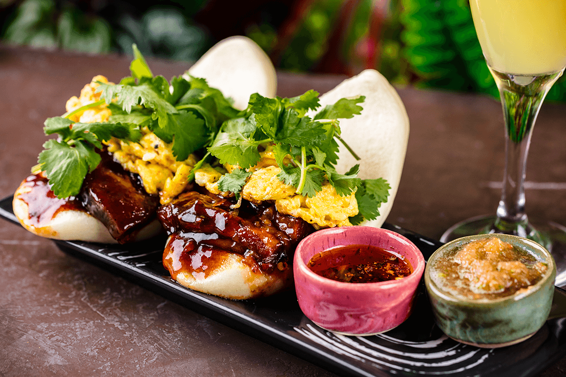 On the brunch menu at Casa Sensei in Fort Lauderdale, Fla., the Rise N Shine Bao Buns are loaded with pork belly, scrambled eggs and a smoky tomato relish. 