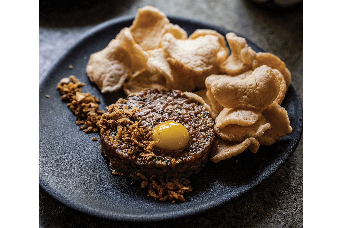 The Beef Koi at New York’s Sama Street updates the classic beef tartare, adding Thai chile sauce and quail egg, rounding out the look with shrimp crackers.