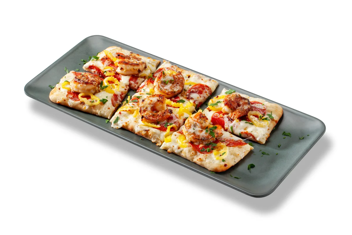 Transform flatbread by starting the build with a base of Ken’s Home Style Ranch Dressing. In this Angry Shrimp Pepe Flatbread, the ranch offers a cooling counterpoint to the heat of such toppings as pepperoni, banana peppers and shrimp tossed in Sweet Baby Ray’s® Garlic Parmesan Wing Sauce.